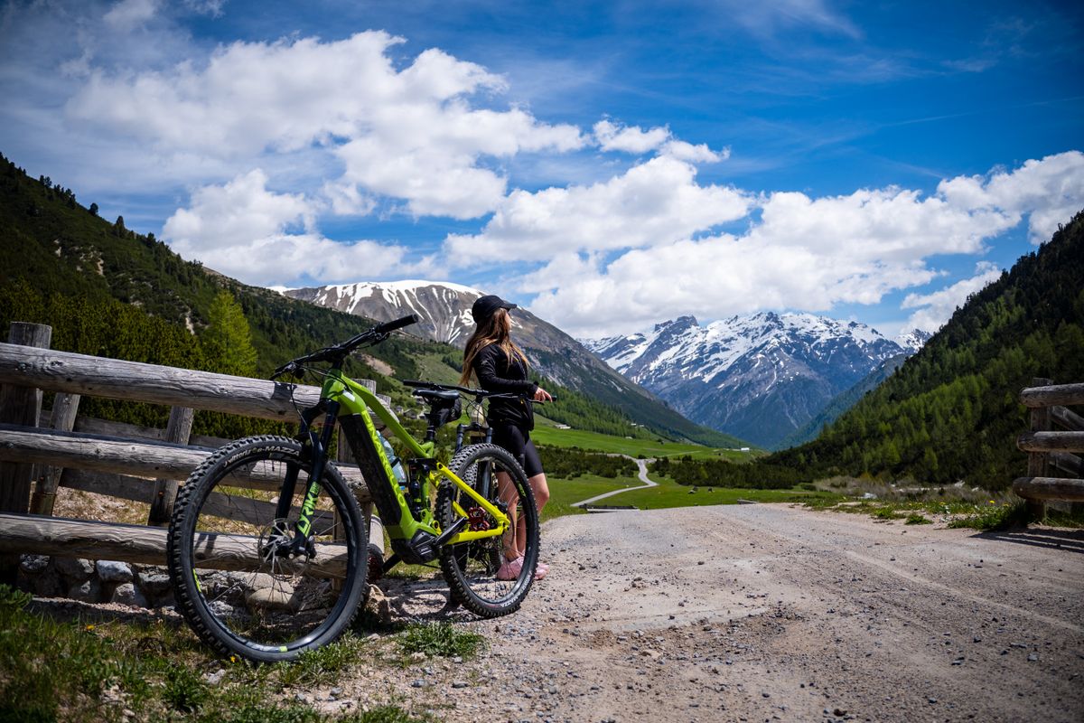 Cyclist riding an e-bike on a scenic mountain road